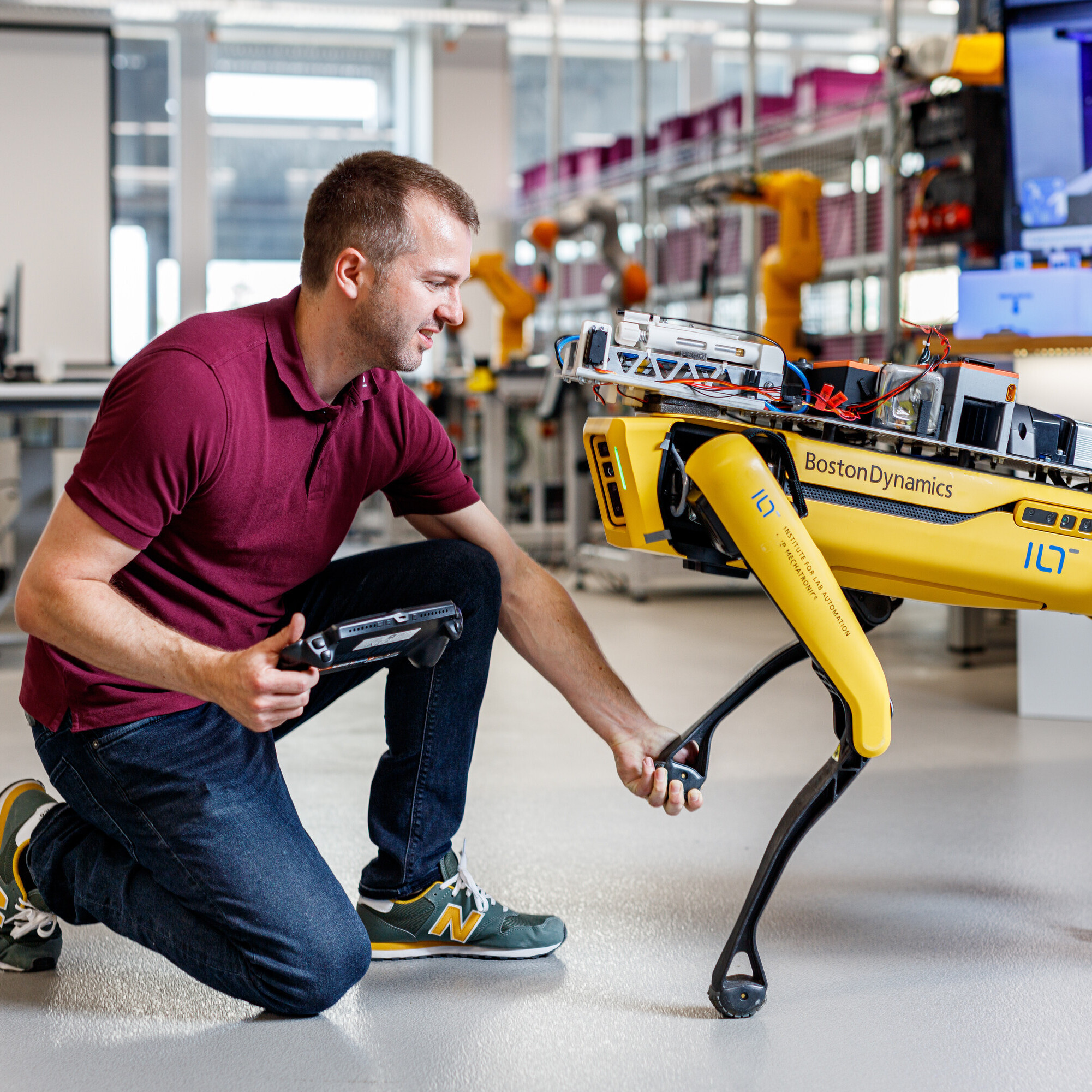 Ein Mitarbeiter des RoboticLab der OST konfiguriert einen roboterhaften Hund.