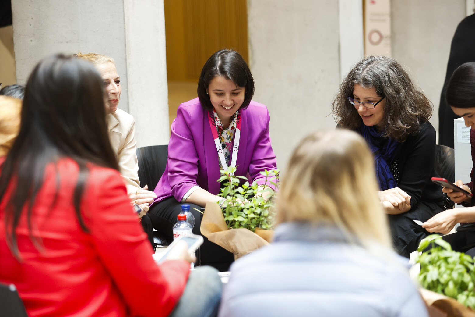 Während des femalITy-Anlasses sitzen Frauen im Foyer des Fachhochschulzentrums St. Gallen im Kreis, tauschen sich aus und lachen. 