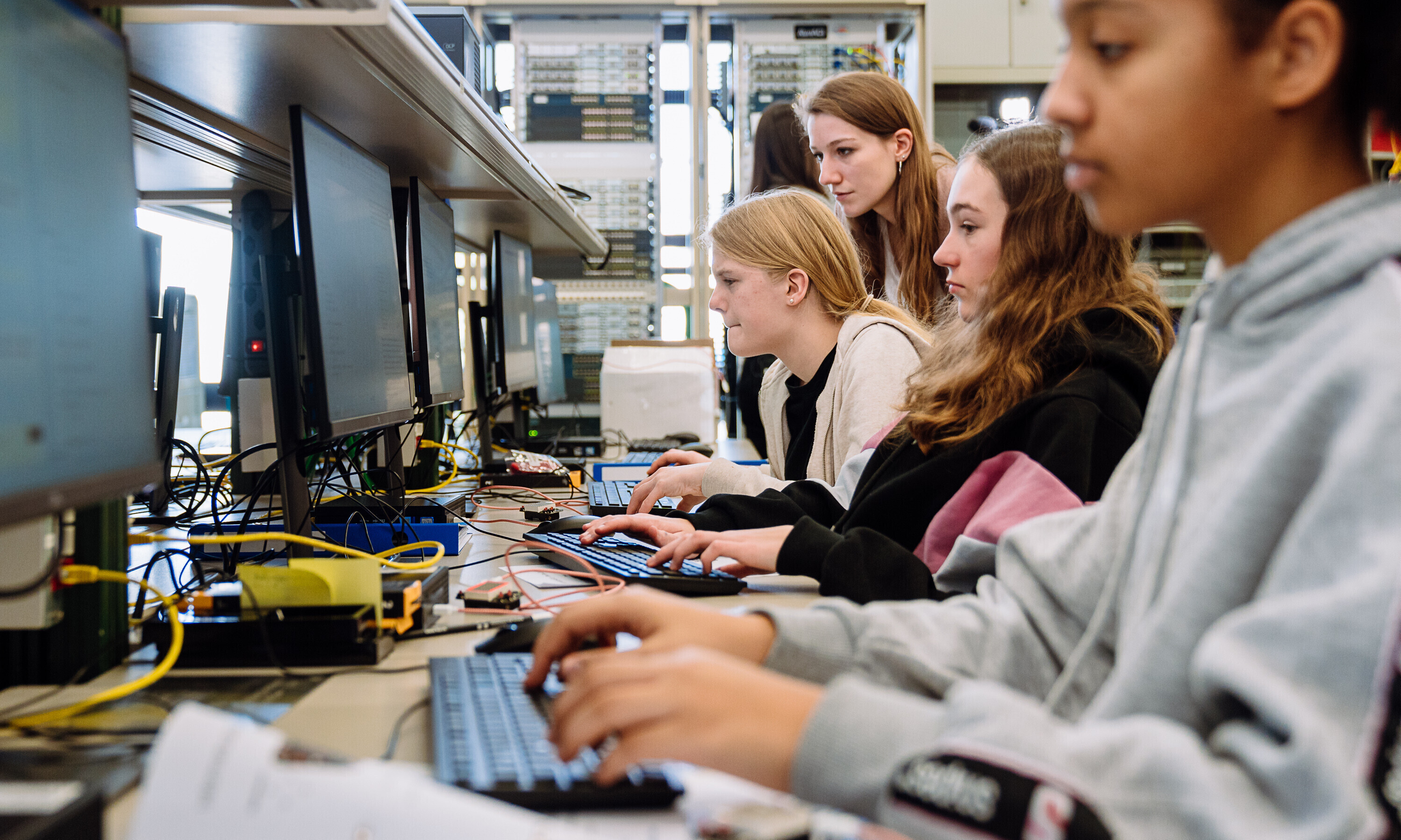 Junge Frauen sitzen vor Computern und sind gefragte Fachkräfte in der Informatikbranche. 