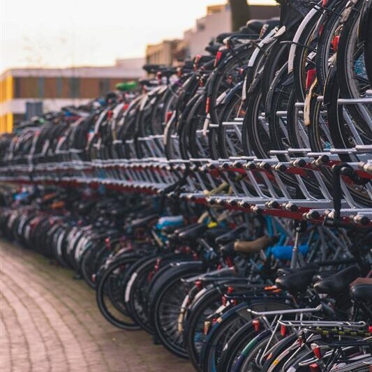 Auf diesem Bild sieht man die Hinterräder vieler Velos in den doppelstöckigen Veloständern am Bahnhof.