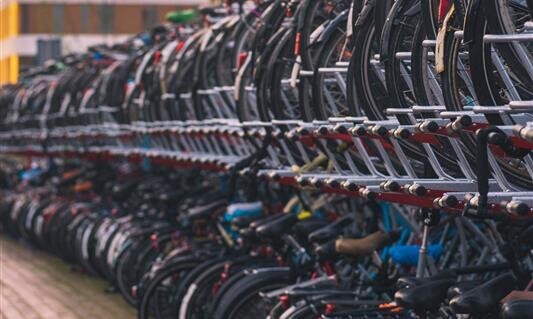 Auf diesem Bild sieht man die Hinterräder vieler Velos in den doppelstöckigen Veloständern am Bahnhof.